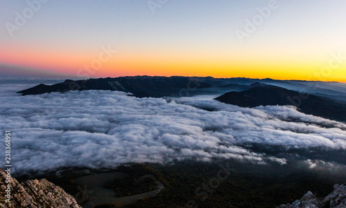 Beautiful sunset in the mountains with low clouds