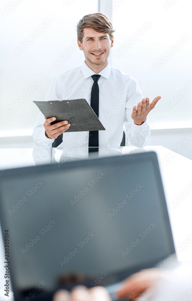 businessman with a clipboard sitting at the negotiating table. businessman with a clipboard sitting at the negotiating table.
