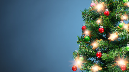 Christmas tree part with shiny decorations, blue background