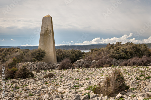 Old concrete triangular pillar on the island of Cres