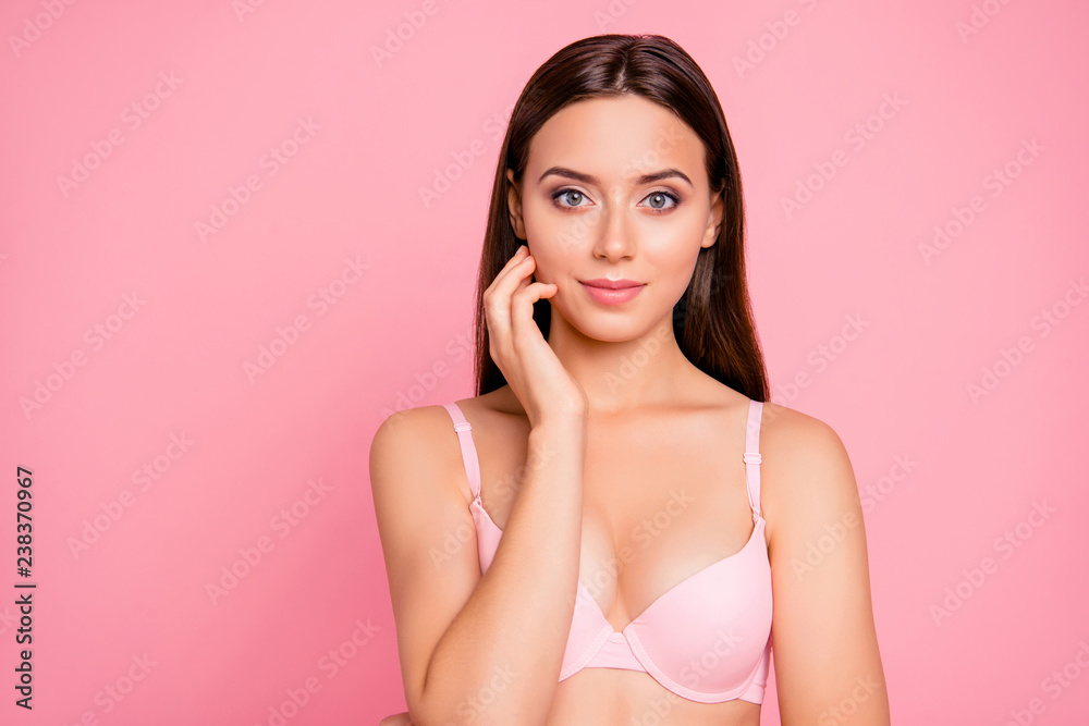 Foto de Close up portrait of cute tender gentle touching with arm cheek  nude her she young girl wearing pale pink bra isolated on rose background  do Stock