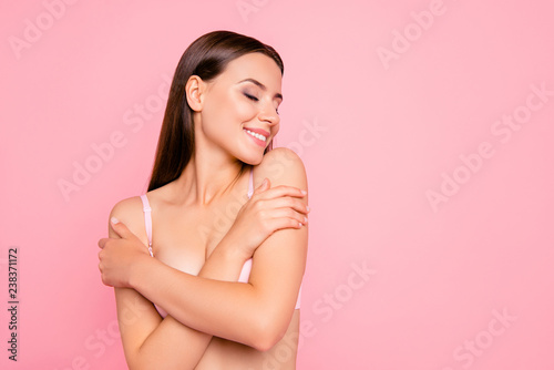 Close up portrait of gorgeous gentle tender with crossed folded hands eyes closed getting pleasure from aromatic smell her she woman wearing pale pink bra isolated on rose background
