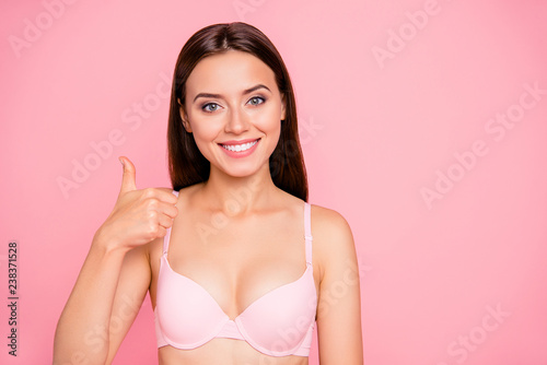 Close up portrait of feminine gorgeous gentle tender hand symbolizing approval of cosmetics quality her she woman wearing pale pink bra isolated on rose background