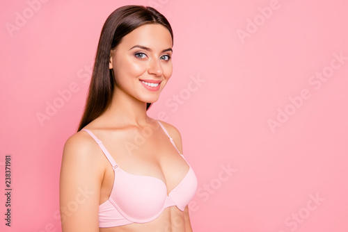 Half turned close up photo of glad gorgeous beautiful tenderness she her woman breast cleavage wearing pale pink bra flawless isolated on rose background photo