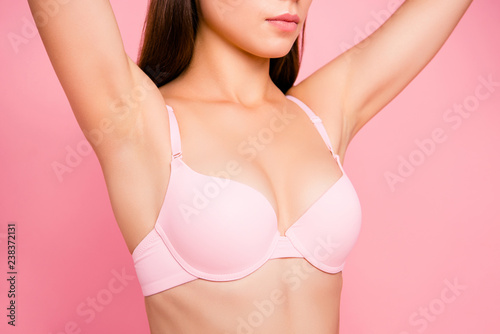 Cropped close up portrait of tenderness gentle she her woman with perfect lovely decollete in pale pink bra showed on first plan isolated on rose background photo