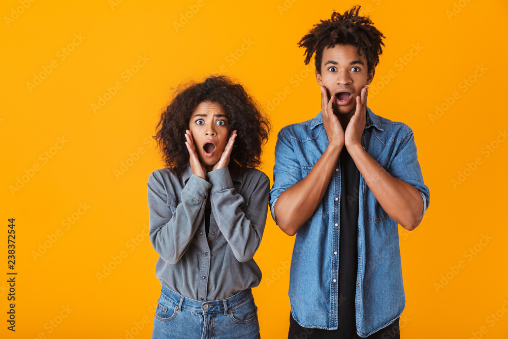 Shocked young african couple standing Shocked young african couple standing