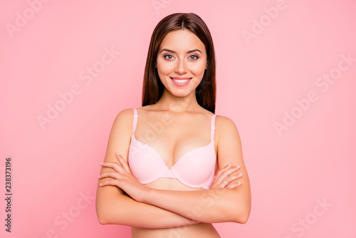 Close up portrait of attractive tenderness gorgeous gentle her she girl with folded hands touching soft fresh shoulders skin gladly looking on camera in pink underwear isolated on pink background