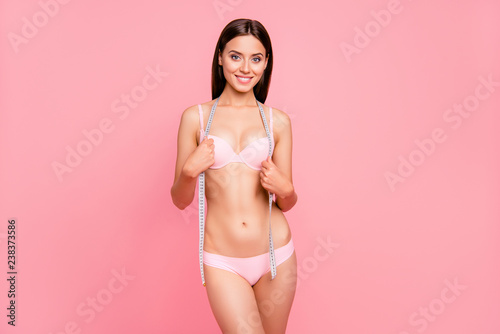 Portrait of nice sporty sportive fit thin girl holding tape healthy lifestyle calories fat obesity treatment therapy problem solving isolated over pink background