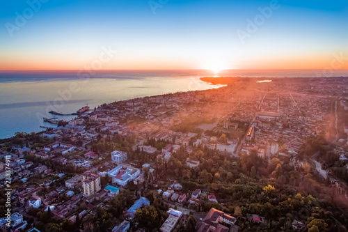 Aerial photography of the urban landscape of Sukhumi at sunset.