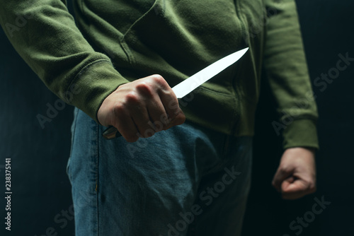 фотографія A robber with a big knife - a sharp-assassin murderer about to commit murder, robbery, theft