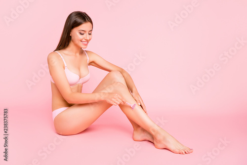 Full length body size photo of amazing glad attractive she her lady in bathroom shower satisfied of razor from advertisement in pale pink bra isolated on rose background