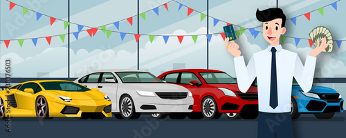 Happy businessman, seller stand and holding a credit card and money in front of group luxury car that parking in large showroom in the city.