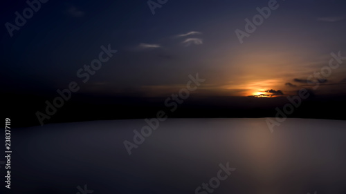 Landscape shot of sun setting with some clouds in the ancient lake.