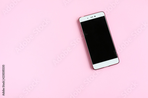 Kiev, Ukraine - 12.09.2018 Mobile phone with black screen and pink case on neutral pastel background with empty space for image or text. Device for wireless communication with selective focus 