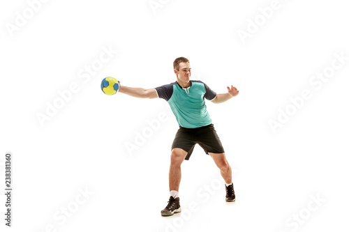 Fototapeta Naklejka Na Ścianę i Meble -  The fit caucasian young male handball player at studio on white background. Fit athlete isolated on white. The man in action, motion, movement. attack and defense concept