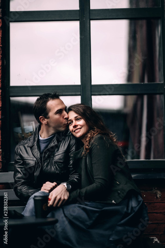  fashionable loving couple in the street cafe in the cold. European people in love. © velimir