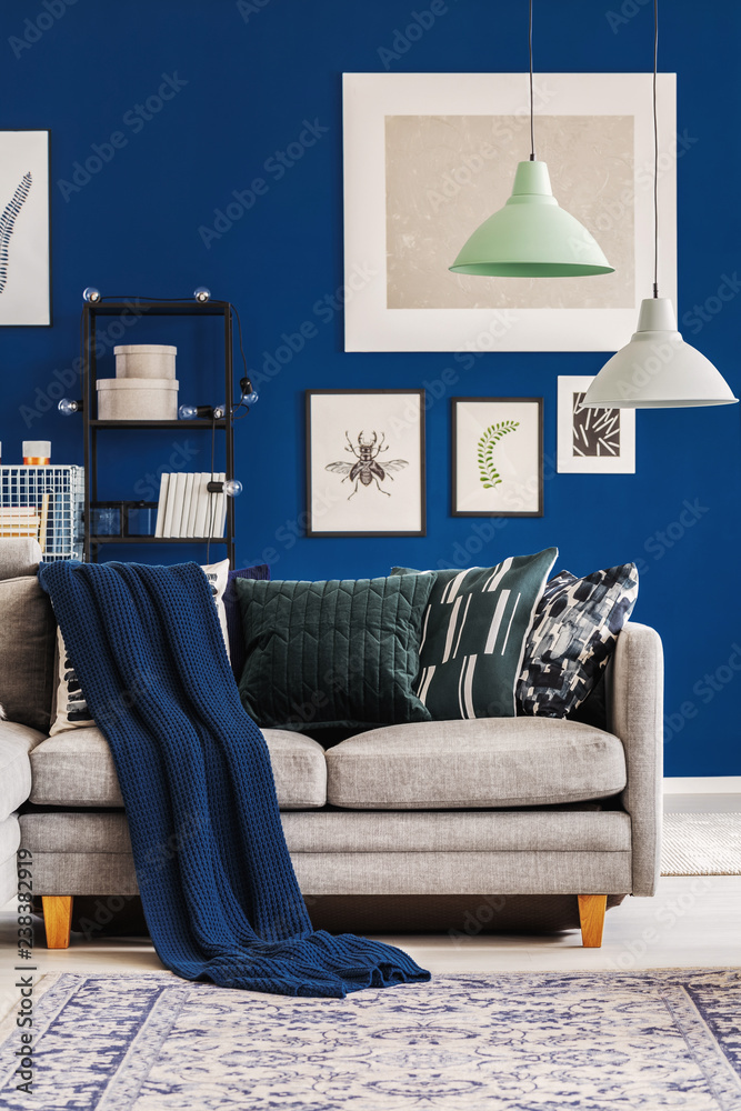 Light grey couch with blue pillows top