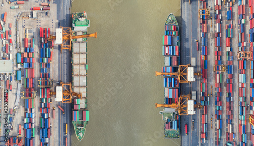 Container ship in export and import business and logistics. Shipping cargo to harbor by crane. Water transport International. Aerial view and top view.