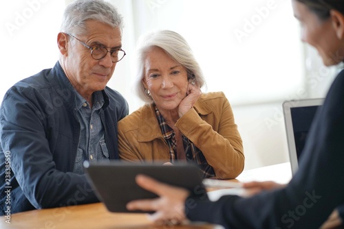  Modern senior couple going through remodelling ideas on tablet