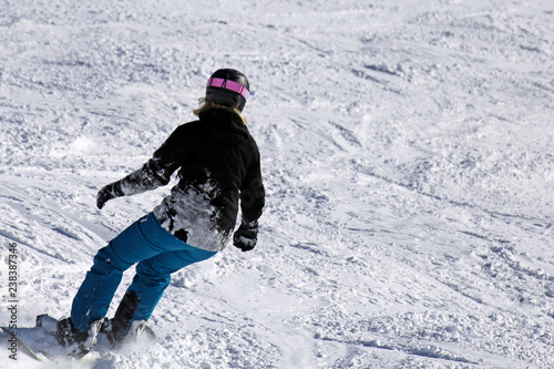 Snowboarder riding the slope