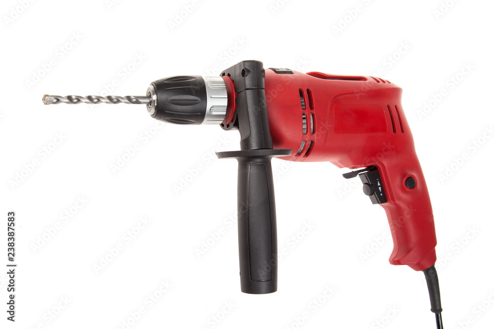 Red electric drilling machine with drill bit isolated on a white background. Red electric drilling machine with drill bit isolated on a white background.
