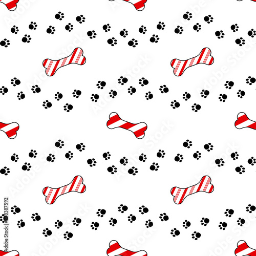 Vector seamless pattern with candy cane bone treat and dog paw prints.