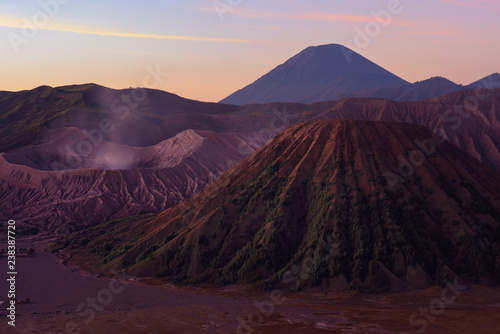 Mount Bromo volcano crater erupts in the caldera, behind Gunung Batok, with Gunung Semeru in the background, Java, Indonesia.