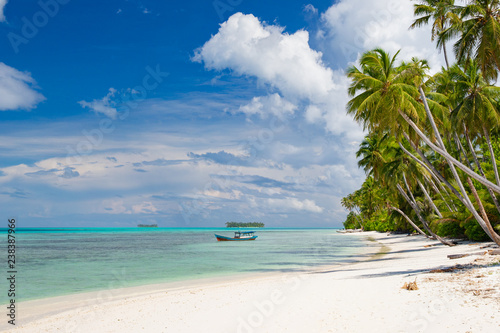 A nice and empty beach in a tropical desert island of pulau Banyak, Sumatra, Indonesia. Blue sky, white sand and coconut trees, a dream holiday place to relax, snorkel and rest. © Gonzalo Jara