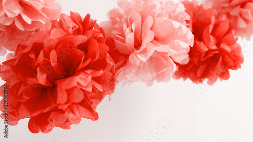 Paper flowers at the girl baby shower party.  Baby shower celebration concept . Living coral theme - color of the year 2019