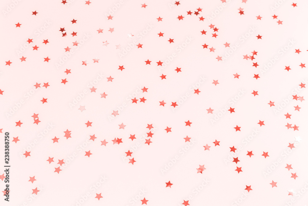 Golden star sprinkles on blue. Festive holiday background. Celebration concept . Living coral theme - color of the year 2019