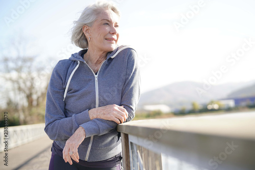  Portrait of attractive senior woman in sportswear outdoors