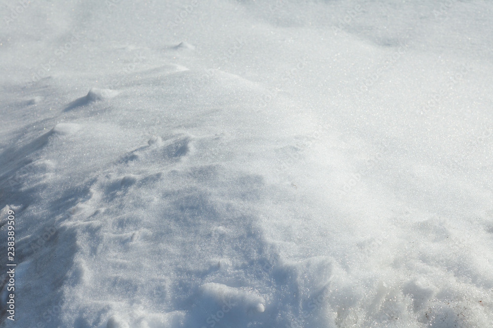 White fresh snow background. Sunny snow view with shades. The texture of a snowdrift. White fresh snow background. Sunny snow view with shades. The texture of a snowdrift.
