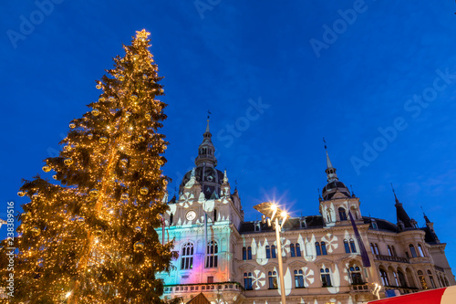 christmas time in graz,the capital of styria,austria. christmassy illuminated townhall on the main square (Hauptplatz) of the city of graz with christmas tree and the memorial for erzherzog johann 