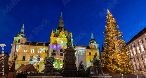 christmas time in graz,the capital of styria,austria. christmassy illuminated townhall on the main square (Hauptplatz) of the city of graz with christmas tree and the memorial for erzherzog johann  photo