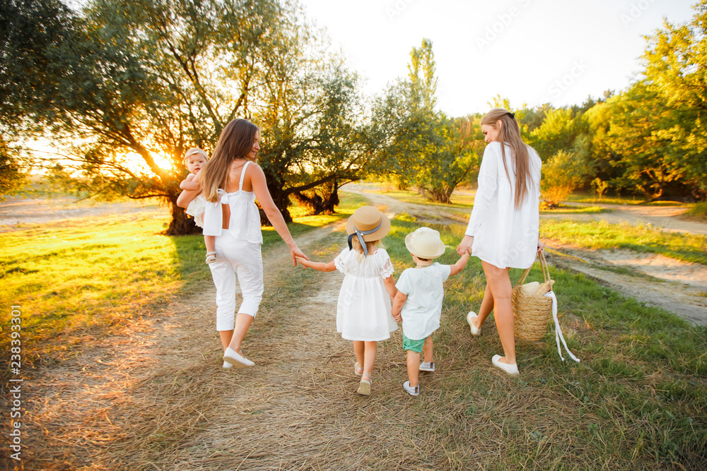 Fototapeta premium A large non-traditional family walks in the autumn forest.