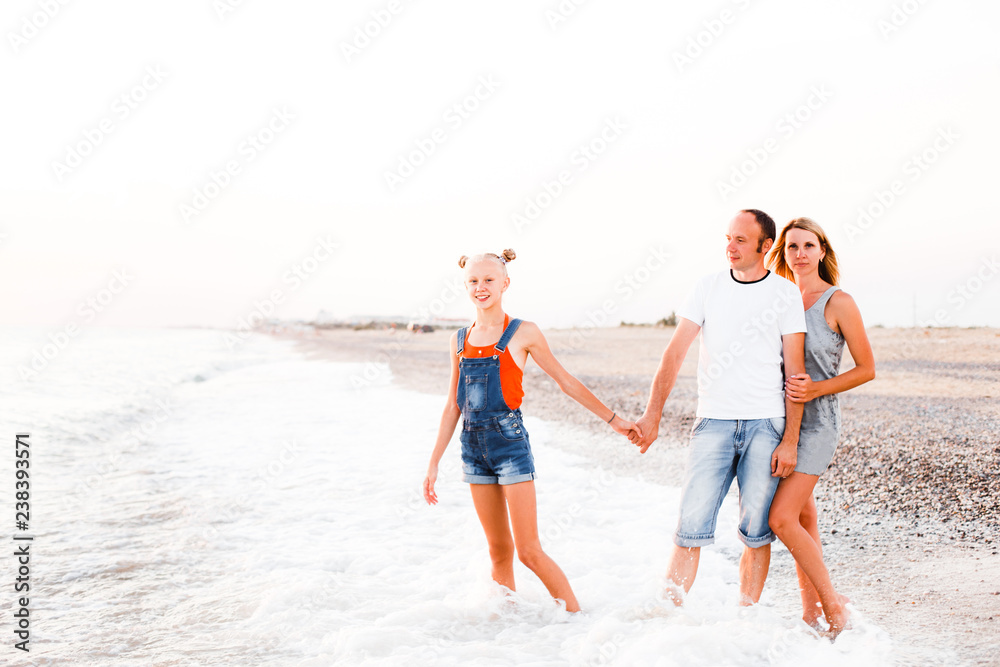 A family with a teenage girl is resting on the sea. A family with a teenage girl is resting on the sea.