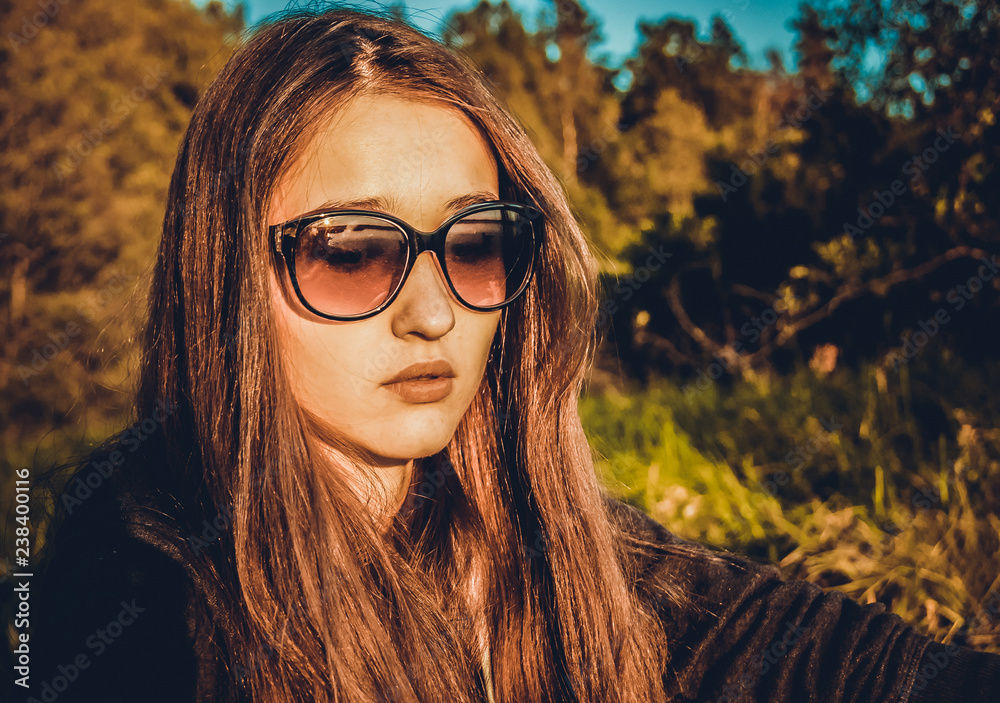 The girl in glasses on the background of nature. The girl in glasses on the background of nature.