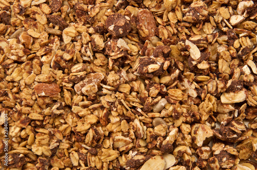 Looking down on home made, all natural, organic granola with chocolate. The cereal fills the entire image.