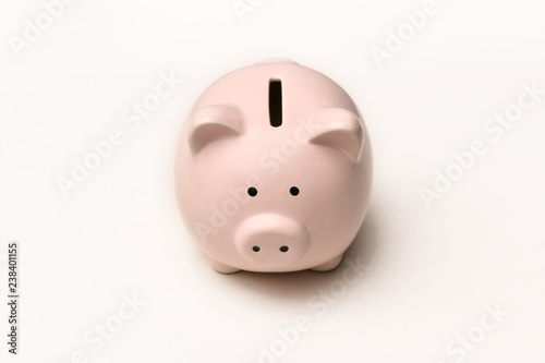 Pink piggy Bank stands on a gray background with a shadow. Horizontal photography