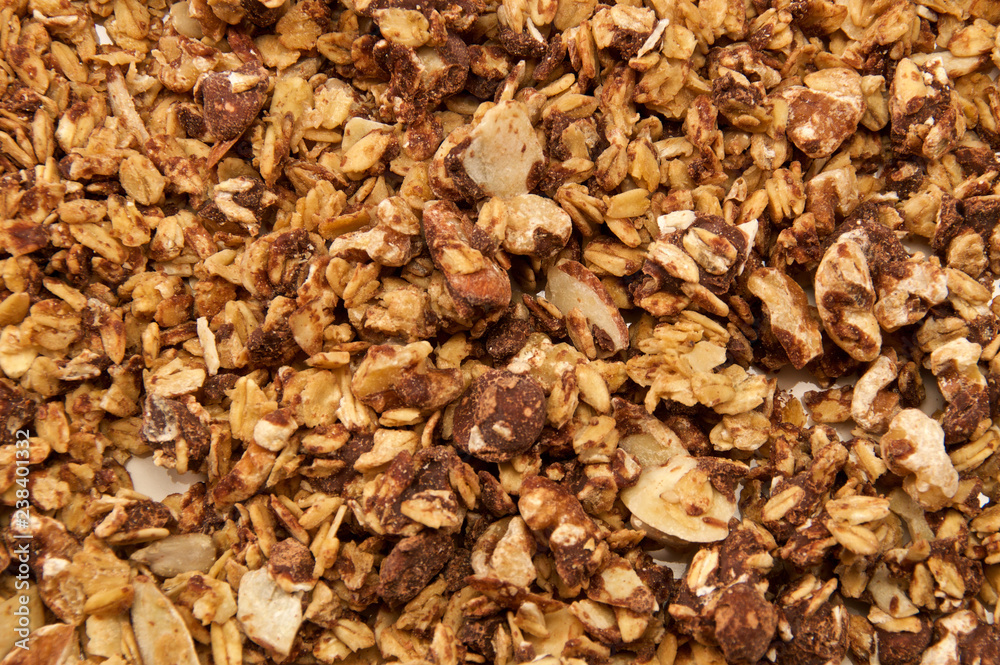 Looking down on home made, all natural, organic granola with chocolate. The cereal fills the entire image.