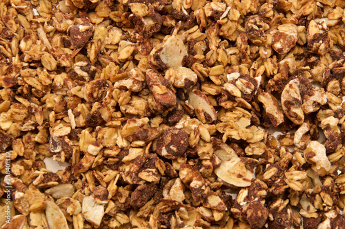 Looking down on home made, all natural, organic granola with chocolate. The cereal fills the entire image.