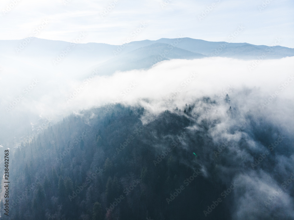 aerial view of clods and fog over mountains hills. magic time