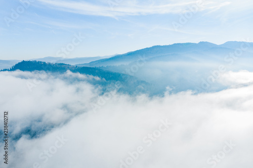 Fototapeta Naklejka Na Ścianę i Meble -  aerial view of clods and fog over mountains hills. magic time