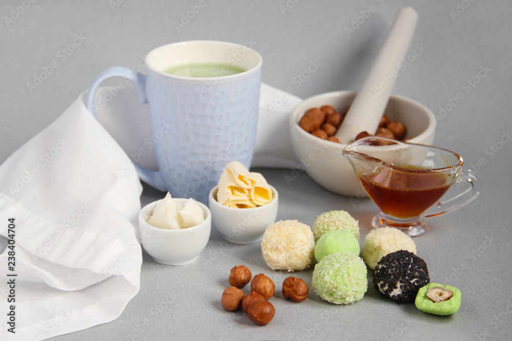 Fat keto peanut butter, cheesecake, matcha balls and keto matcha coconut  bulletproof tea in blue cup. keto protein balls and matcha tea recipes  ingredients. it works ketogenic diet. blue background Photos