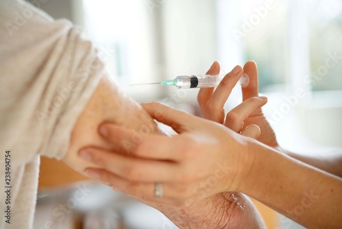 Close up of senior woman geting flu shot