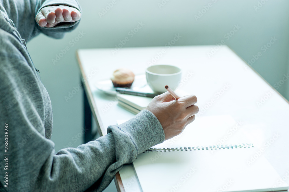 Fototapeta premium Writing on paper at work on the table in the morning, business ideas. There is space for copying.