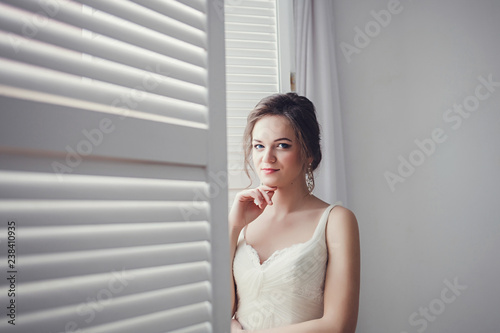 Young bride in wedding dress in room. studio shot