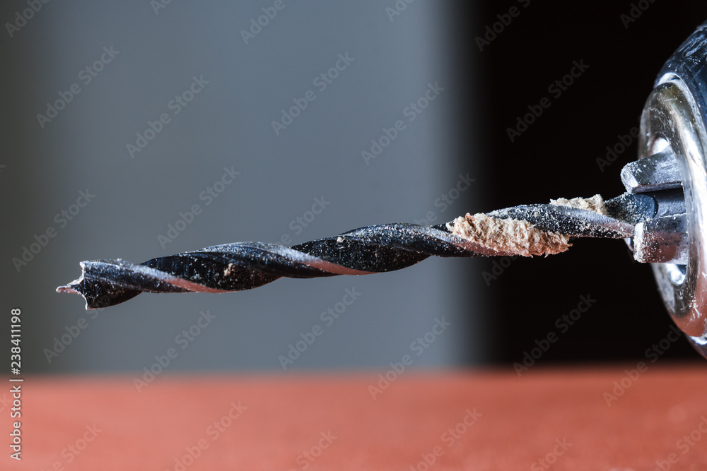 metal drill bit, a wooden plank, surface, kitchen furniture, fibreboard and panels, wood pulp, concept of selection of materials and tools for work, space for text metal drill bit, a wooden plank, surface, kitchen furniture, fibreboard and panels, wood pulp, concept of selection of materials and tools for work, space for text