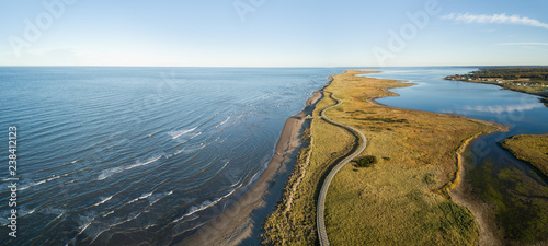 Aerial panoramic view of a beautiful sandy beach on the Atlantic Ocean Coast. Taken in La Dune de Bouctouche, New Brunswick, Canada.