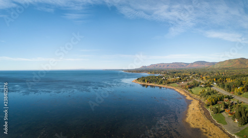 Aerial panoramic view of the Atlantic Ocean Coast during a sunny morning. Taken near Gesgapegiag, Quebec, Canada.